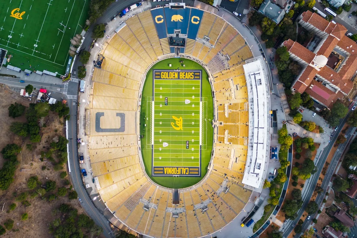 Aerial view of a college football stadium with the field and surrounding campus visible