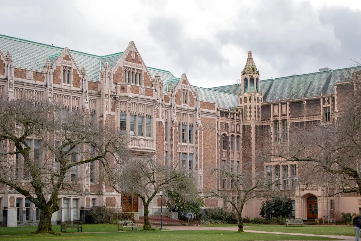 Gothic collegiate buildings with green lawns on a university campus