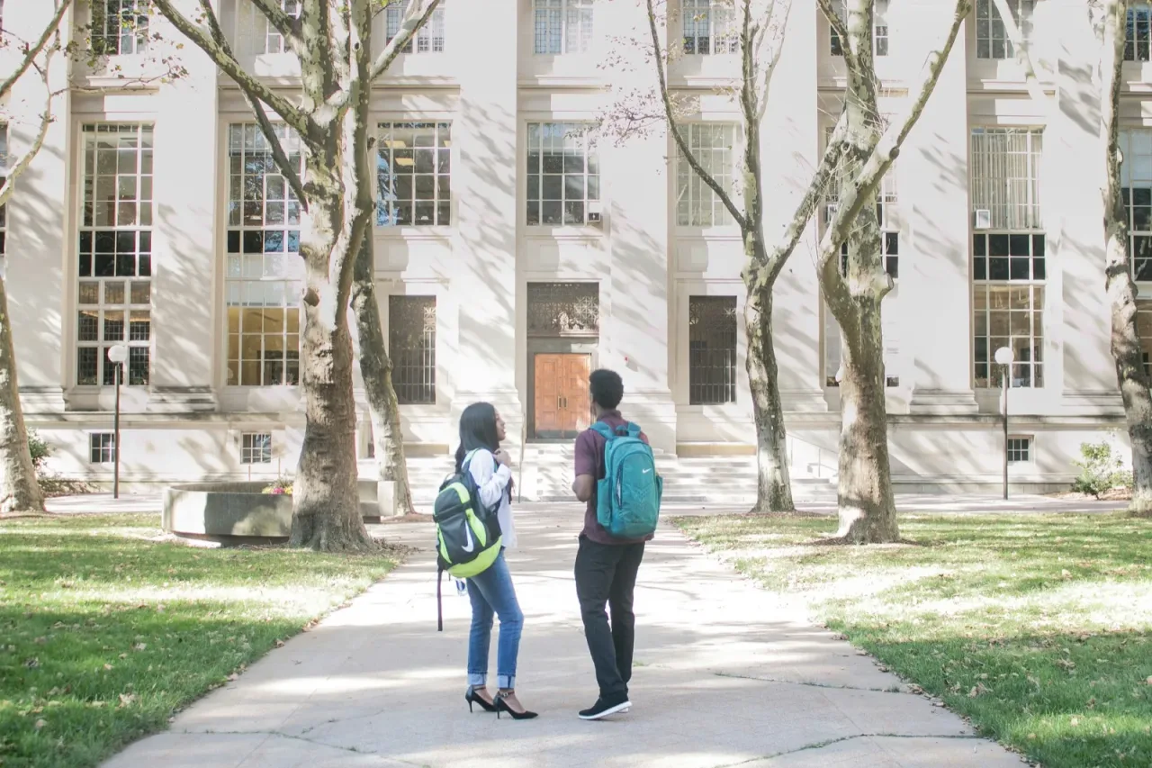 Students walking on a college campus pathway