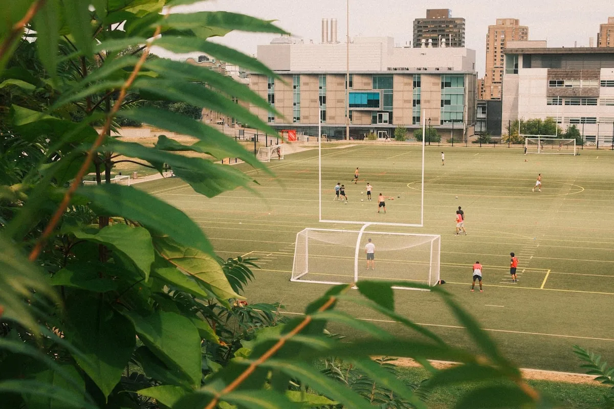 A college campus scene with athletic facilities and green surroundings